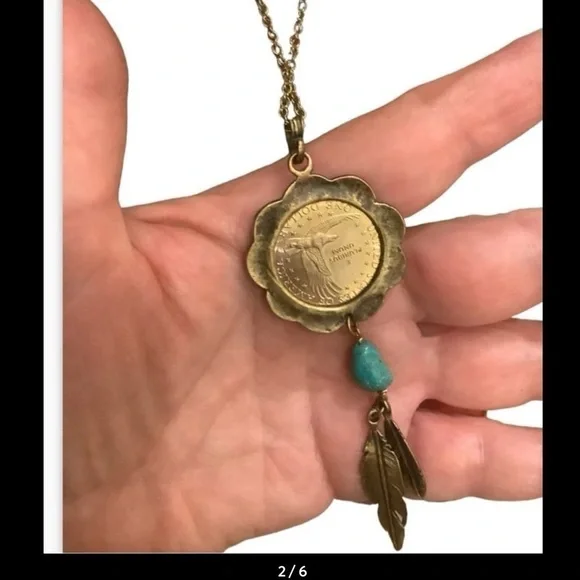 blue turquoise quarter dollar pendant hangs on a 24” gold tone necklace